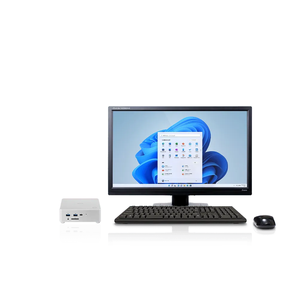 デスクトップPCのセットアップ。モニター、キーボード、マウス、PC本体が写っています。モニターにはWindows 11の画面が表示されています。