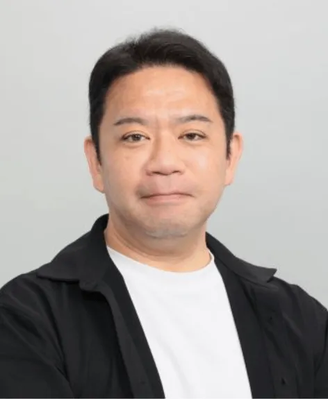 正面を向いた男性のポートレート。彼は黒いシャツと白いTシャツを着ています。背景は白。