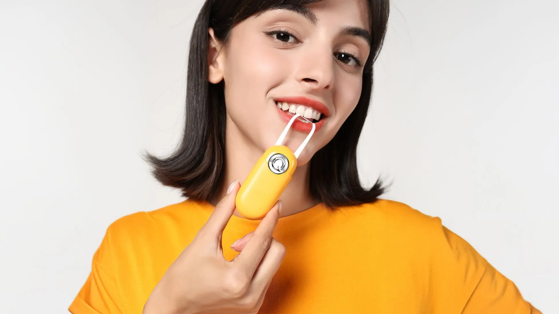 女性が歯ブラシのようなものを持って口を開けている様子