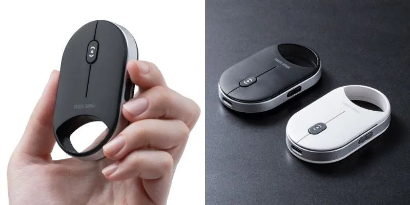 黒と白の2色のワイヤレスマウスの写真。どちらもシルバーの縁取りがあり、中央にボタンがある。片方は人の手で持たれており、もう片方は黒いテーブルの上に置かれている。