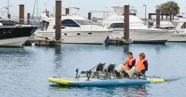 マリーナを背景に水上アクティビティを楽しむカップル