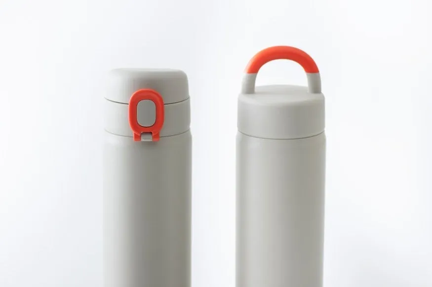 2つのステンレスボトルが並んだ写真。左側のボトルは蓋に赤い留め具があり、右側のボトルは赤い持ち手が付いている。