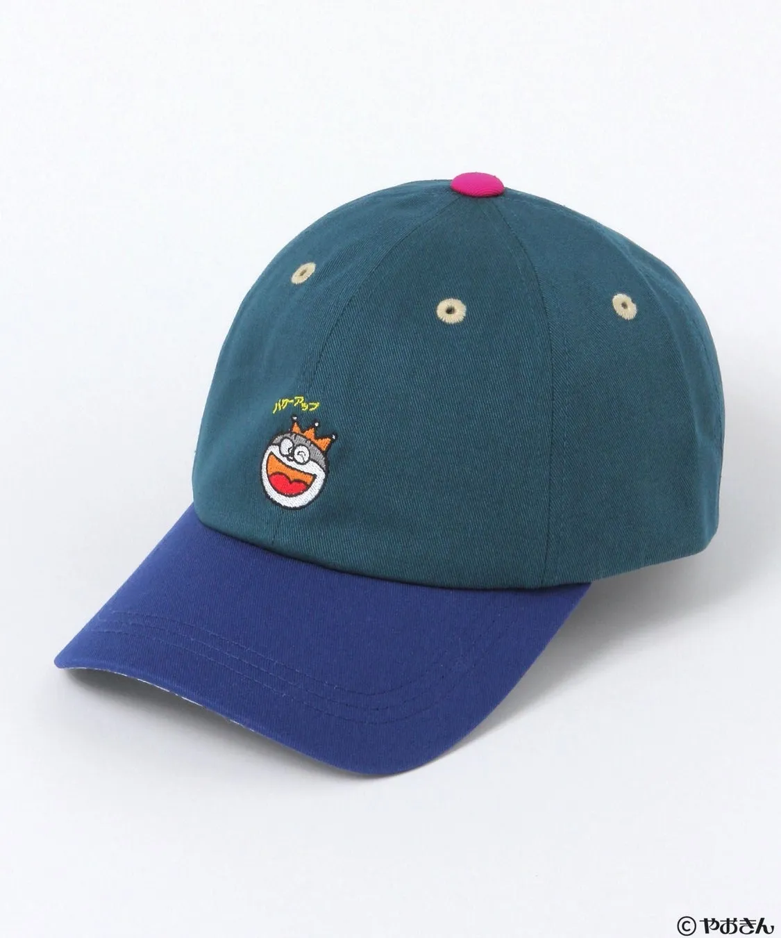 緑と青のツートンカラーの野球帽。帽子の正面には王冠を被ったキャラクターの刺繍があり、その上には「ハゲアップ」の文字が刺繍されています。